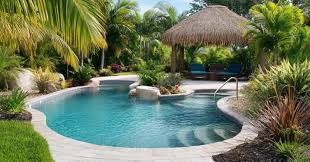 A modern Florida pool with sleek decking and landscaping. - FloridaDetail.Com