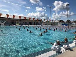 Happy family swimming in a freshly resurfaced pool in North Port, Florida.